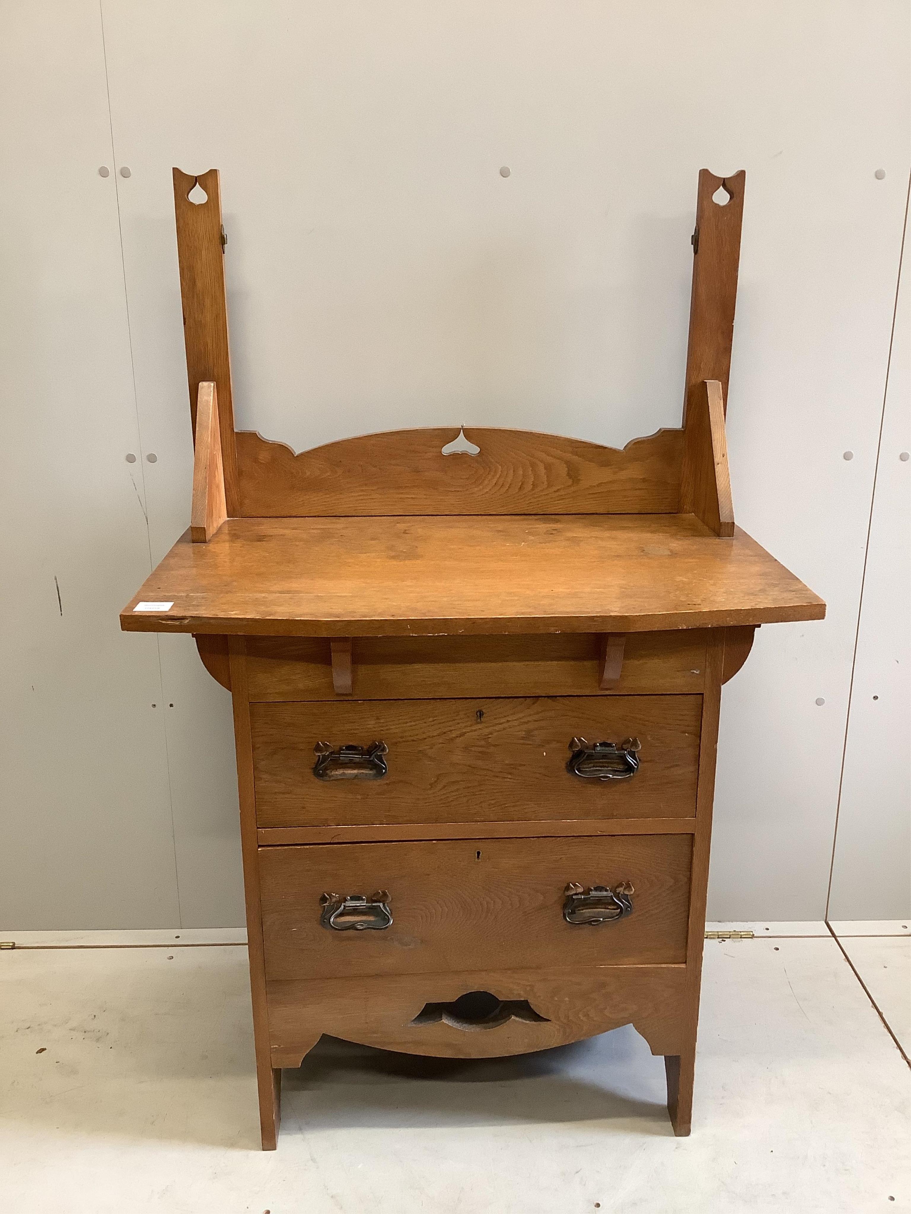 An Arts and Crafts oak dressing chest, (lacking mirror) width 84cm, depth 50cm, height 133cm